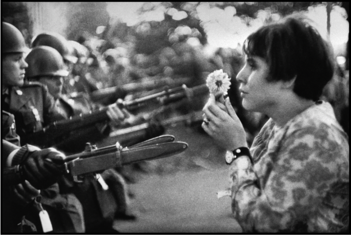 A picture that shows stark contrast between the violence and force of the Vietnam War and people’s hope that they could make it end. This picture was taken in 1967 during an anti-Vietnam march (Photo By: Marc Riboud).